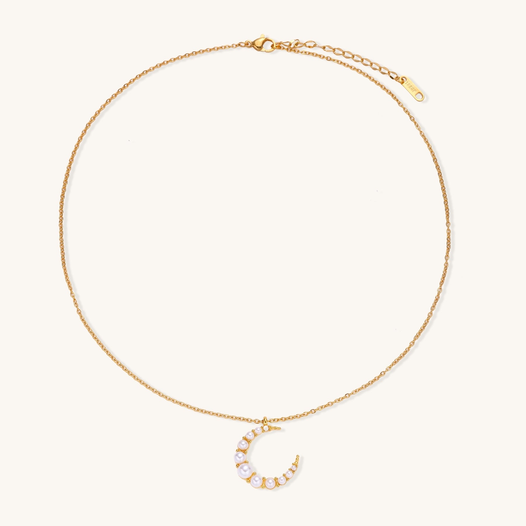 Delicate 18K gold plated necklace featuring crescent moon pendant with white shell pearl beads on neutral background.
